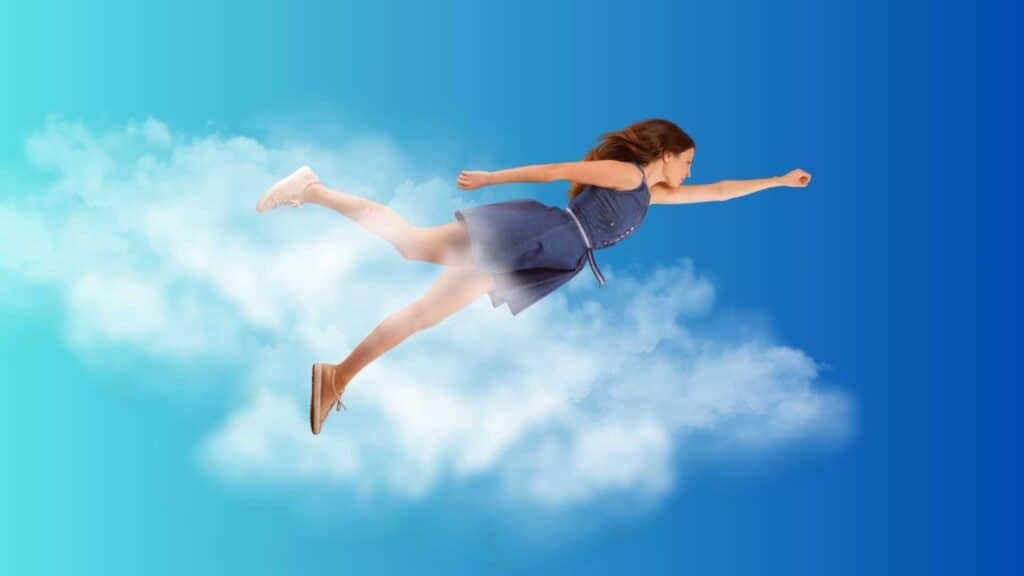 A young woman flying amongst the clouds